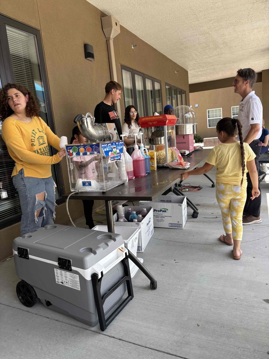 Residents and kids at a fresh produce table